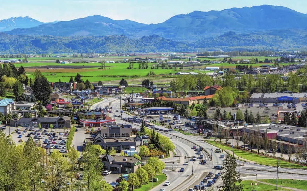 Aerial view of Abbotsford, British Columbia with Fraser Valley farmland and mountains — lawn care service area